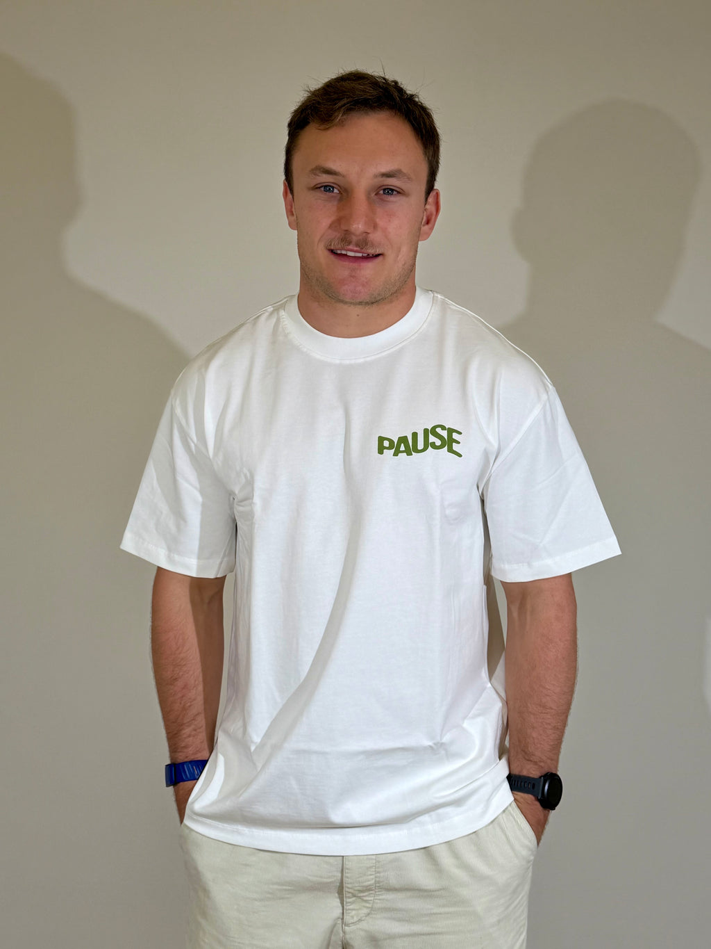 Model wearing white limited edition Pause oversized t-shirt, front view
