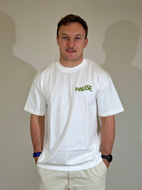 Model wearing white limited edition Pause oversized t-shirt, front view